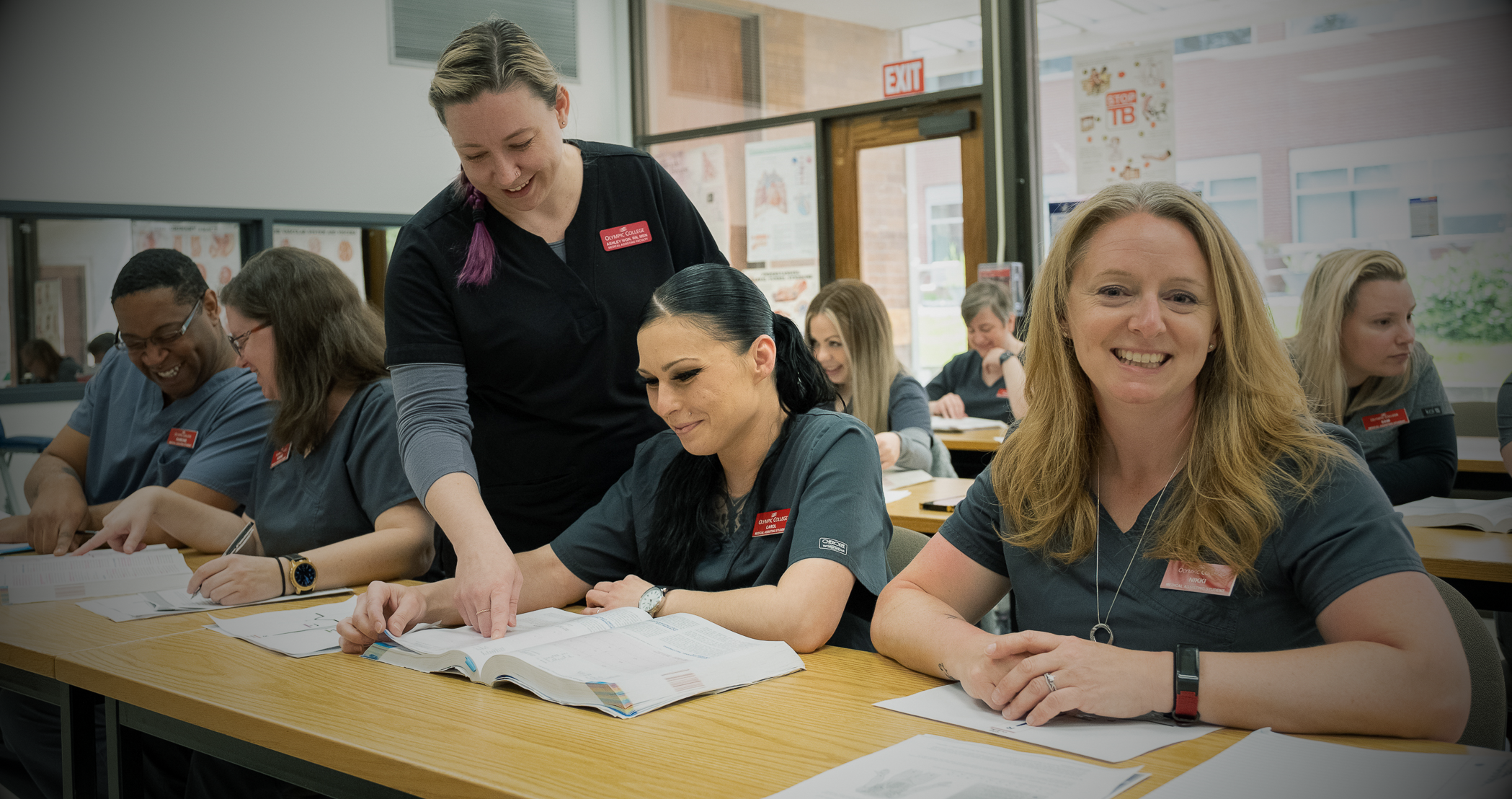 OC instructors helping students in classroom